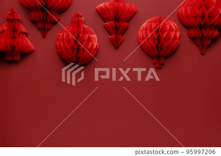 Christmas or New Year background. Red burgundy color flat lay with decorations. Copy space area for advertising or marketing text. Paper balls and fit trees. Simple minimalistic greeting card mockup Christmas or New Year background. Red burgundy color flat lay with decorations. Copy space area for advertising or marketing text. Paper balls and fit trees. Simple minimalistic greeting card mockup 95997206