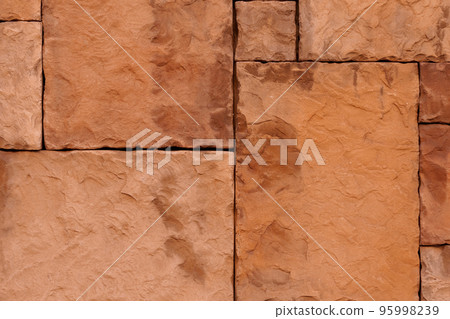 Stone wall texture with rough sandstone tiles and straight lines of joints Stone wall texture with rough sandstone tiles and straight lines of joints 95998239