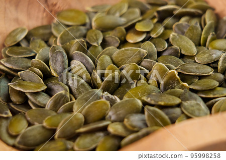 Pumpkin seeds. Raw fresh peeled green ingredient closeup Pumpkin seeds. Raw fresh peeled green ingredient closeup 95998258