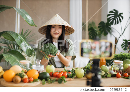 Beautiful female using broccoli, vegetables and fruits preparing healthy salad 95998342