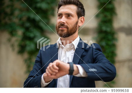 Young businessman waiting for someone and looking anticipated 95999638