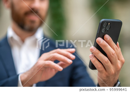 Man holding a smartphone in hand Man holding a smartphone in hand 95999641