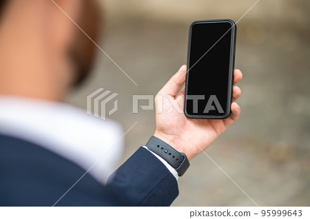 Man holding a smartphone in hand Man holding a smartphone in hand 95999643