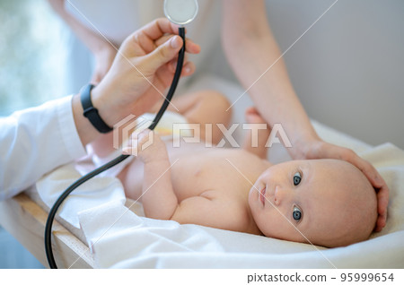 Cute baby having a medical examination in the clinic 95999654