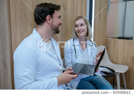 Doctors discussing an interesting case and looking involved 95999681