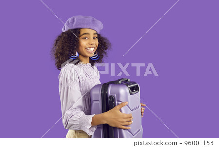 Happy African American girl with suitcase ready for trip Happy African American girl with suitcase ready for trip 96001153