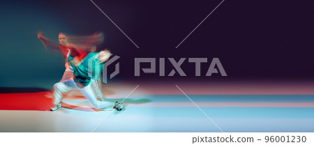 Portrait of young man and woman dancing isolated over green purple background in neon with mixed lights. Flyer Portrait of young man and woman dancing isolated over green purple background in neon with mixed lights. Flyer 96001230