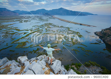 Aerial view of Dalyan river, Iztuzu beach, sea, mountains and lakes. Happy hiker man above the wild nature  96001400