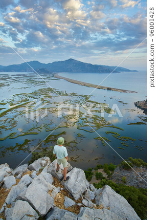 Aerial view of Dalyan river, Iztuzu beach, sea, mountains and lakes. Happy hiker man above the wild nature  96001428