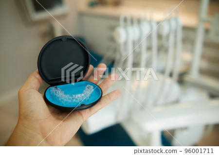 Two invisible dental aligners in the personal box. Orthodontic plastic transparent braces for teeth straightening  96001711