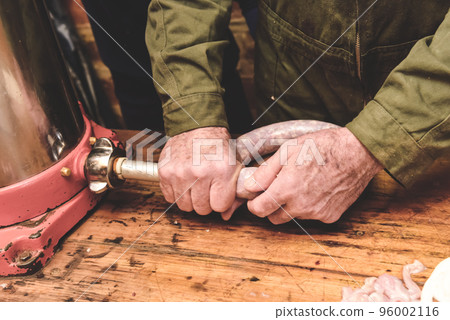 Hands making homemade sausages, Patagonia, Argentina 96002116