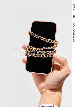 Conceptual image of phone with chain symbolizing blockchain system. Storage and distribution of information. Cryptocurrency system 96002321