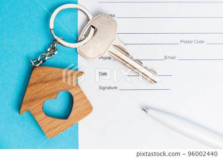 New key with a brel house on a blue background with documents and pen. Flat lay. Mortgage and lending concept New key with a brel house on a blue background with documents and pen. Flat lay. Mortgage and lending concept 96002440