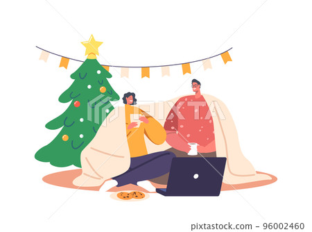 Young Loving Couple Sitting in on Floor Living Room Drinking Tea, Chatting, Watching Movie on Laptop during Christmas 96002460