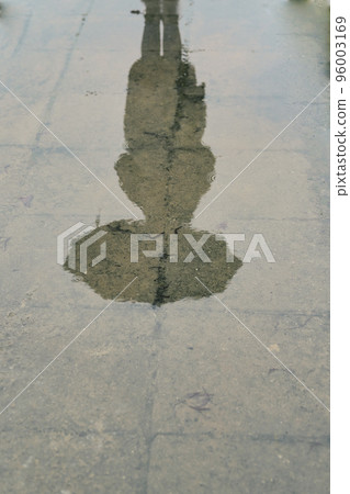 puddle reflection silhouette of a girl with an umbrella. reflection in water puddle reflection silhouette of a girl with an umbrella. reflection in water 96003169