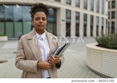 a woman of African American appearance, an official stands against the background of an a woman of African American appearance, an official stands against the background of an 96003190