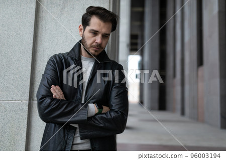 drooping man in a depressed state with arms crossed on his chest stands and looks down drooping man in a depressed state with arms crossed on his chest stands and looks down 96003194