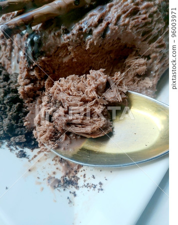 Close up of Bingsu dessert ice flake chocolate in spoon with whip cream and milk Close up of Bingsu dessert ice flake chocolate in spoon with whip cream and milk 96003971