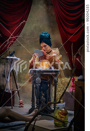 Beautiful mysterious soothsayer and molfarka guesses and predicts fate. Retro circus, mysticism and witchcraft. Concept of art, creativity and inspiration 96004285