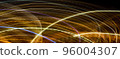 Abstract long exposure original light painting photography. Curvy lines of glowing gold against a black background. Christmas holiday seasonal wallpaper decoration 96004307