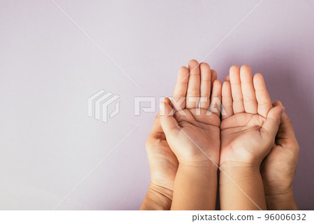 Top view parents and little kid holding empty hands together studio shot isolated on pink background, family home, hands children on adult mother hand, help support, parents family day concept Top view parents and little kid holding empty hands together studio shot isolated on pink background, family home, hands children on adult mother hand, help support, parents family day concept 96006032