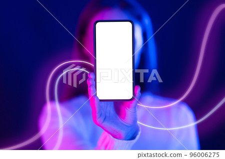 Unrecognizable woman hiding behind cell phone with blank screen, mockup Unrecognizable woman hiding behind cell phone with blank screen, mockup 96006275