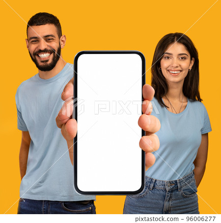 Great App. Happy Arab Couple Demonstrating Big Blank Smartphone With White Screen 96006277
