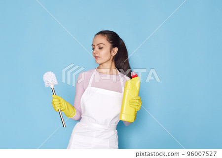 woman in gloves and cleaner apron holding toilet brush woman in gloves and cleaner apron holding toilet brush 96007527