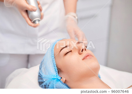woman receiving facial massage at spa salon woman receiving facial massage at spa salon 96007646