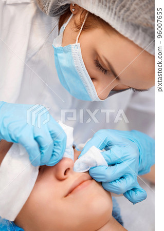 woman during a mechanical face cleansing procedure woman during a mechanical face cleansing procedure 96007655