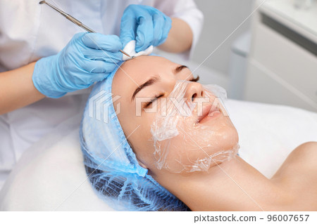 woman during a mechanical face cleansing procedure woman during a mechanical face cleansing procedure 96007657