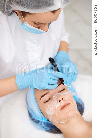 face of woman while procedure ultrasonic cleansing face of woman while procedure ultrasonic cleansing 96007658