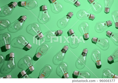 Close-up of an incandescent lamp on green background. Close-up of an incandescent lamp on green background. 96008377