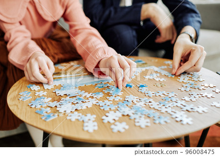 Family Doing Puzzles Closeup Family Doing Puzzles Closeup 96008475