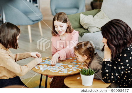 Family with Three Children Doing Puzzles Family with Three Children Doing Puzzles 96008477