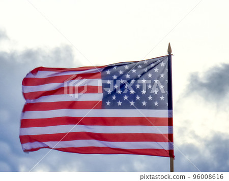 American flag flying in the wind, rain clouds 96008616