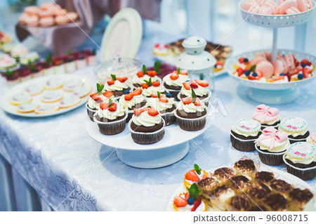 Delicious sweets on wedding candy buffet with desserts, cupcakes 96008715