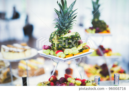 Delicious and tasty dessert table with cupcakes shots at reception closeup 96008716
