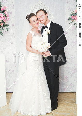 Perfect couple bride, groom posing and kissing in their wedding day 96008717