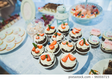 Delicious sweets on wedding candy buffet with desserts, cupcakes 96008723