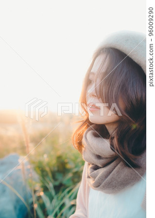 日落時站在大自然中的女人的照片 96009290