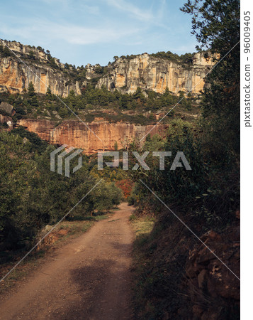 Landscape with a dirt road in the mountains with forest in Siurana, El Priorat, Catalonia, Spain. Landscape with a dirt road in the mountains with forest in Siurana, El Priorat, Catalonia, Spain. 96009405