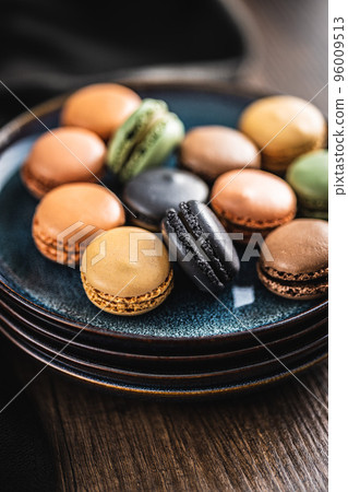 Sweet macaron dessert. Colorful macarons on plate. 96009513