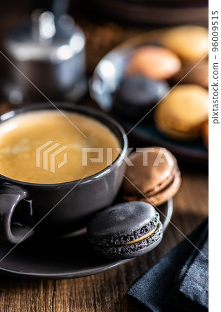 Sweet macaron dessert. Macarons with coffee flavor and coffee cup. 96009515