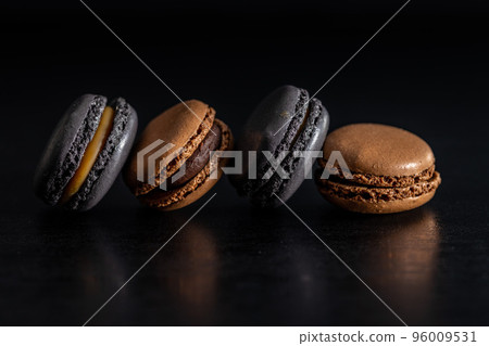Sweet macaron dessert on black table. Sweet macaron dessert on black table. 96009531