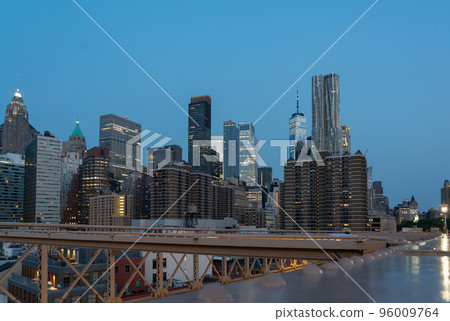Evening panorama of New York skyscrapers on Manhattan Island view from the Brooklyn Bridge Evening panorama of New York skyscrapers on Manhattan Island view from the Brooklyn Bridge 96009764