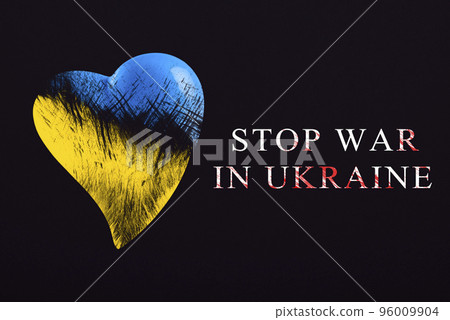 Stop war in Ukraine. Save Ukraine. The heart is painted in the colors of the Ukrainian flag - blue and yellow. Stop war text, poster on black background 96009904