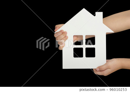 House in hand, isolation. White model of a house in the hands of a child isolated on a black background. Homeless housing, family home, home insurance, international family day House in hand, isolation. White model of a house in the hands of a child isolated on a black background. Homeless housing, family home, home insurance, international family day 96010253
