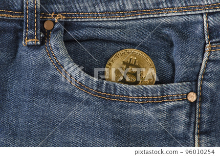 Bitcoin in your pocket. A golden bitcoin coin lies in the pocket of blue jeans. Salary in bitcoins, income in cryptocurrency. Bitcoin in your pocket. A golden bitcoin coin lies in the pocket of blue jeans. Salary in bitcoins, income in cryptocurrency. 96010254