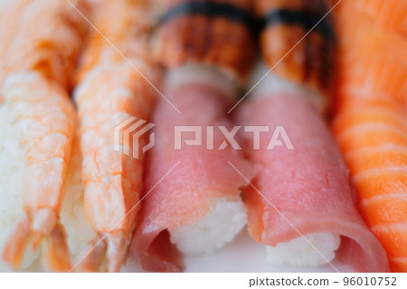 A close-up photography of a set of sushi rolls. Home delivery, Japanese cuisine A close-up photography of a set of sushi rolls. Home delivery, Japanese cuisine 96010752